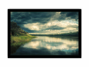 Moody lake Canvas Print with dramatic clouds and reflections