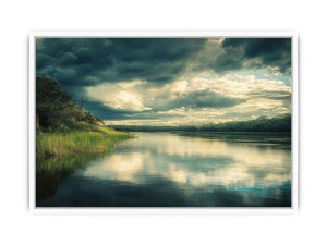 Moody lake Canvas Print with dramatic clouds and reflections