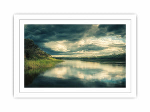 Moody lake Canvas Print with dramatic clouds and reflections