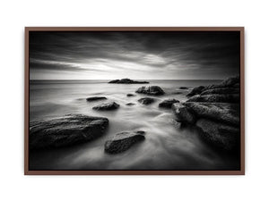 Black and white ocean wall art with dramatic coastal rocks, misty waves, and moody storm clouds in contemporary monochrome seascape style