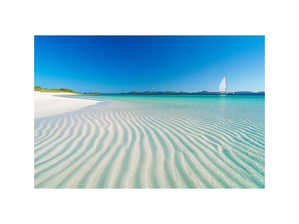 Tropical shoreline with sailboat and turquoise water for coastal living room decor