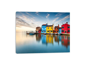 Serene waterfront at dawn with reflections