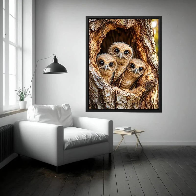Curious owlets in tree hollow