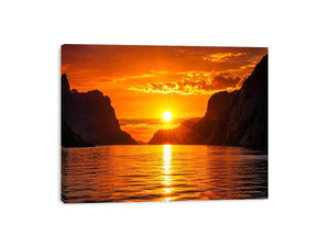 Golden sunset over fjord cliffs