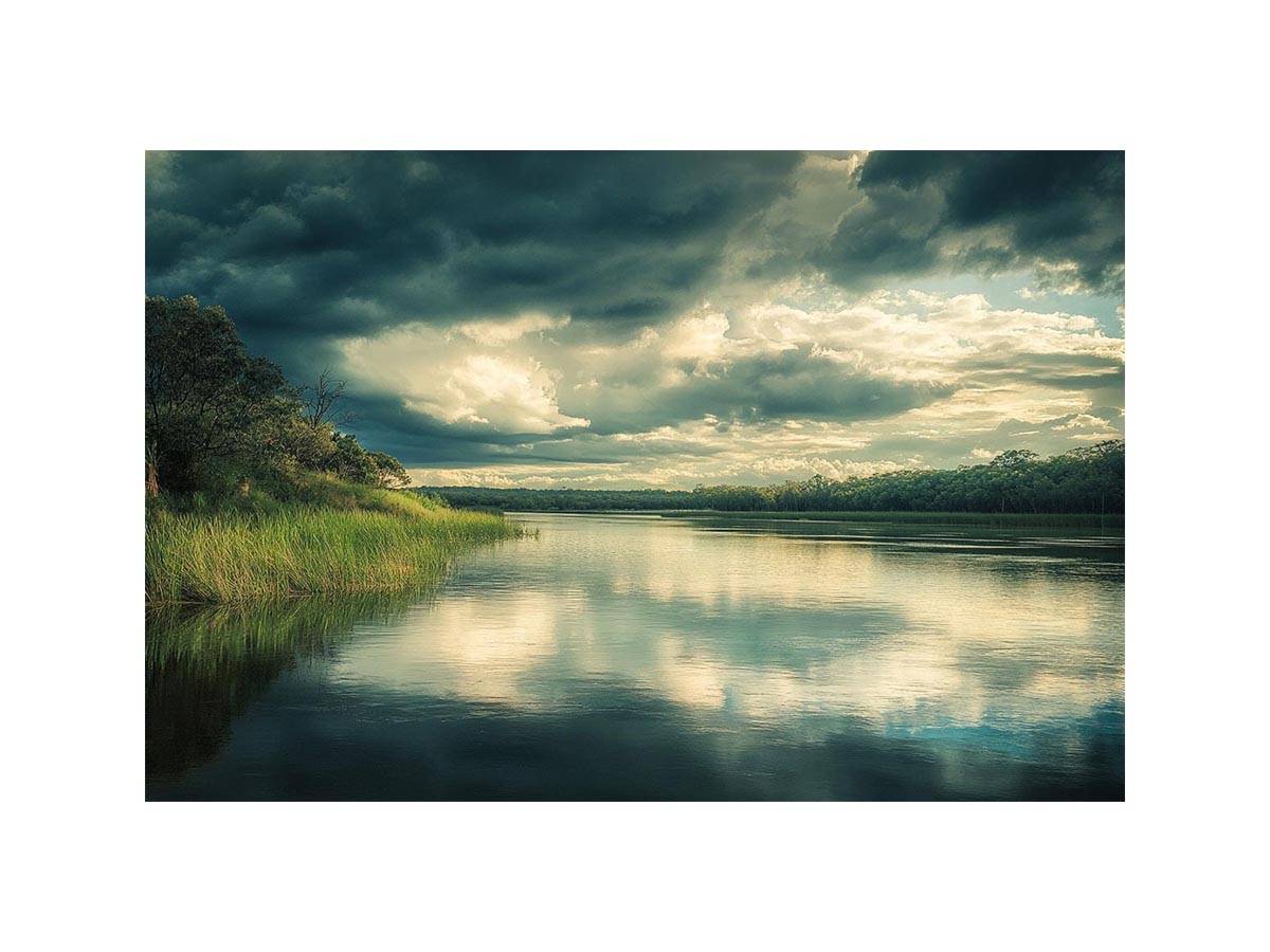 Moody lake Canvas Print with dramatic clouds and reflections