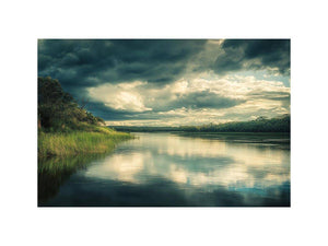 Moody lake Canvas Print with dramatic clouds and reflections