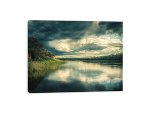 Moody lake Canvas Print with dramatic clouds and reflections