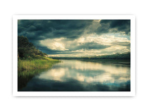 Moody lake Canvas Print with dramatic clouds and reflections