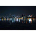 Night city skyline artwork with reflections