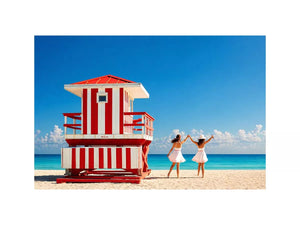 Minimal coastal beach scene with red lifeguard hut blue ocean and two women walking aesthetic Canvas Print