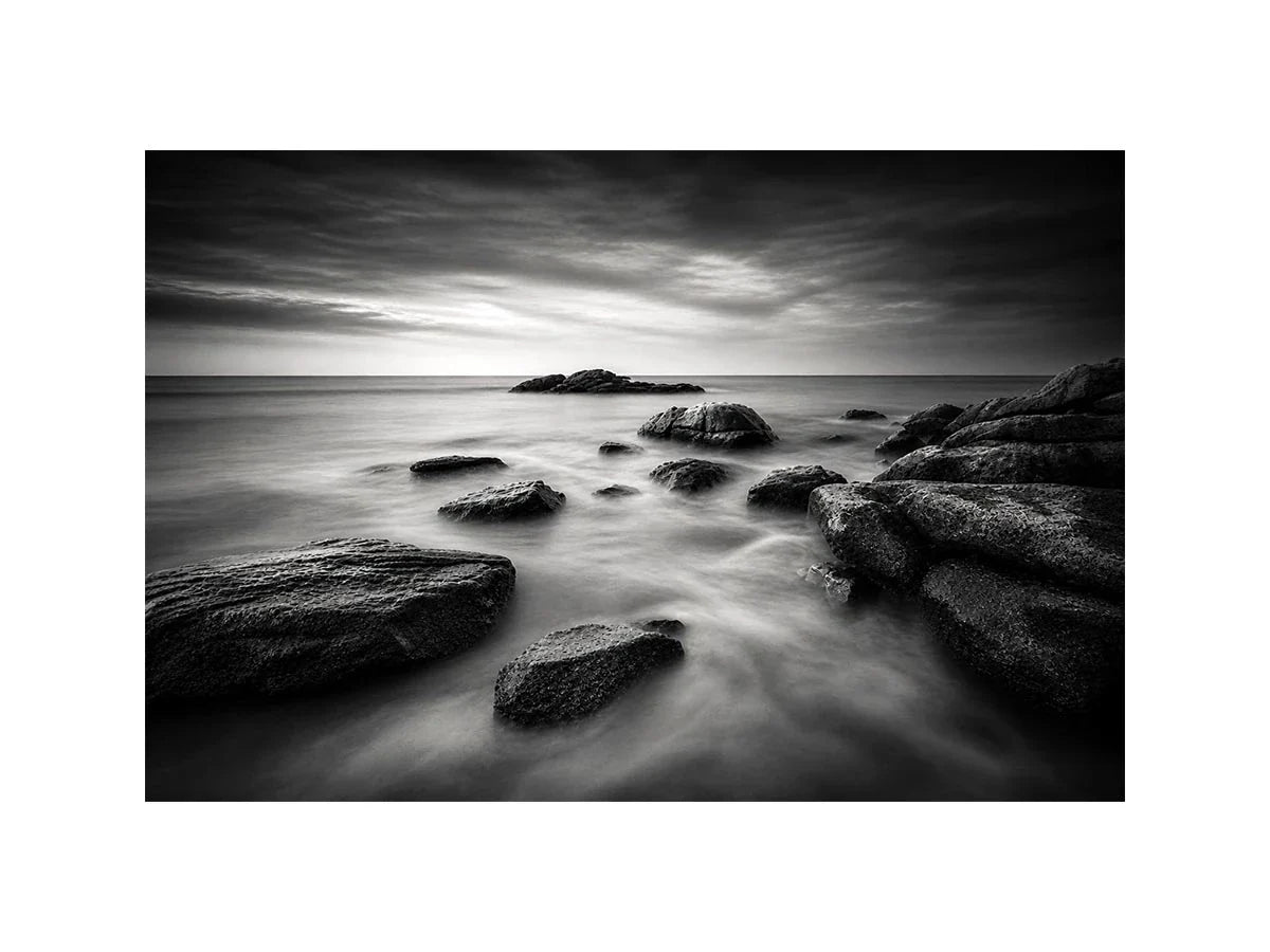 Midnight Tide Black and white ocean wall art with dramatic coastal rocks, misty waves, and moody storm clouds in contemporary