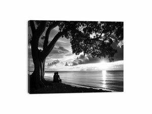 Black and white coastal silhouette canvas print with tree, ocean, and couple for peaceful bedroom decor.